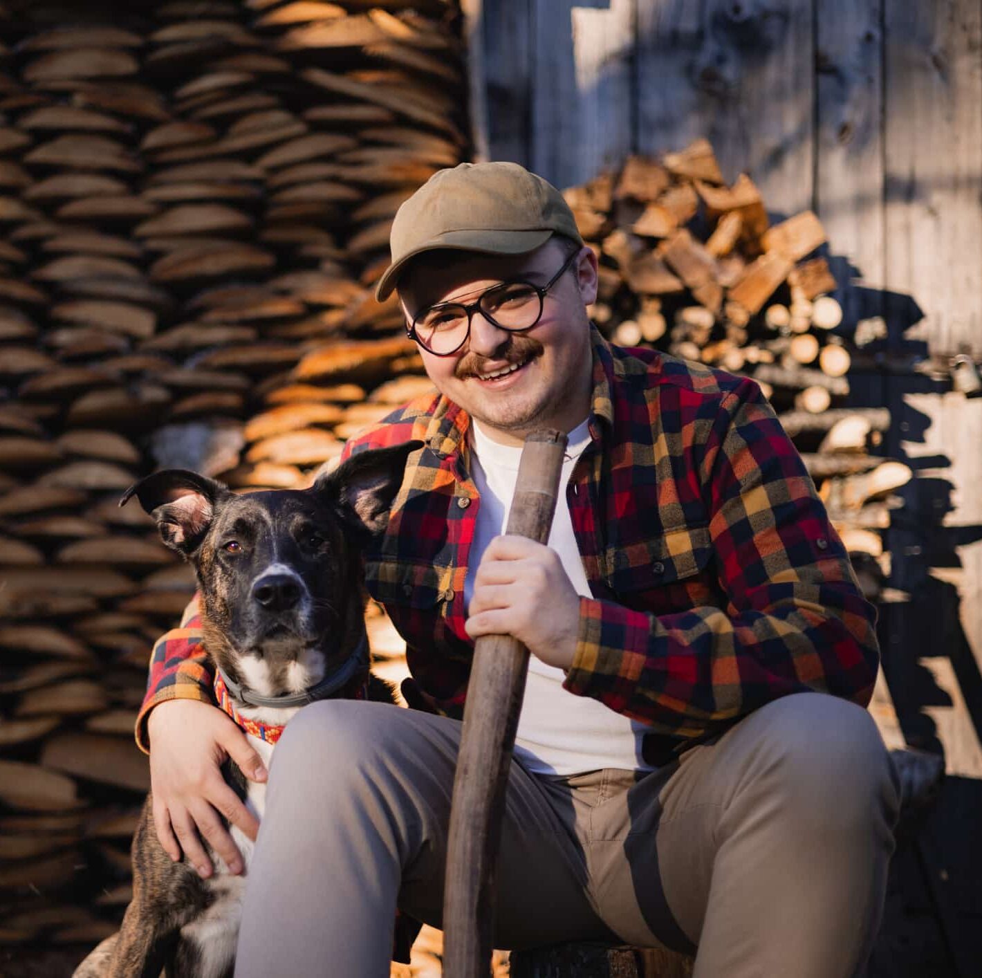 Portrait of a hardworking Caucasian male lumberjack sitting in front of his home